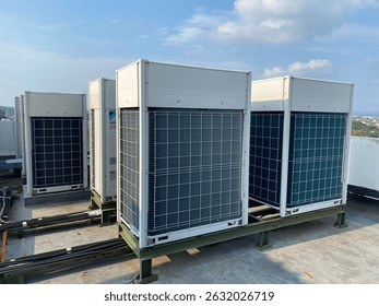 Outdoor view of multiple VRV (Variable Refrigerant Volume) or VRF (Variable Refrigerant Flow) commercial air conditioning units installed on a rooftop. These high-efficiency HVAC systems are commonly 
