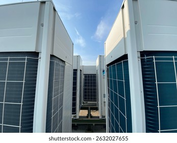 Outdoor view of multiple VRV (Variable Refrigerant Volume) or VRF (Variable Refrigerant Flow) commercial air conditioning units installed on a rooftop. These high-efficiency HVAC systems are commonly 