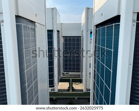 Outdoor view of multiple VRV (Variable Refrigerant Volume) or VRF (Variable Refrigerant Flow) commercial air conditioning units installed on a rooftop. These high-efficiency HVAC systems are commonly 
