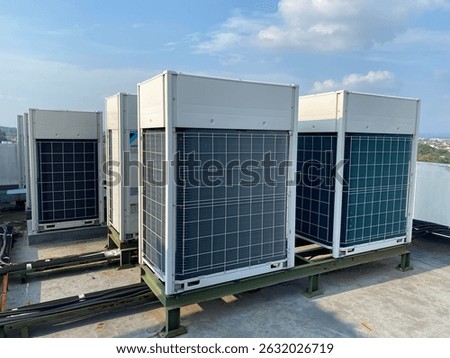 Outdoor view of multiple VRV (Variable Refrigerant Volume) or VRF (Variable Refrigerant Flow) commercial air conditioning units installed on a rooftop. These high-efficiency HVAC systems are commonly 