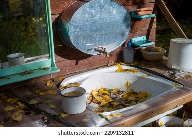 Outdoor Washbasin, Mirror And A Sink Clogged With Autumn Leaves, No People