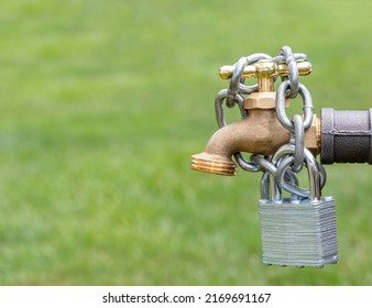 Outdoor Water Faucet With Lock And Chain. Water Restriction, Supply And Shortage Concept