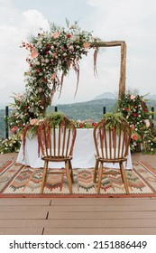 Outdoor Wedding Altar Setup, With Flower Decoration And Mountain Background.