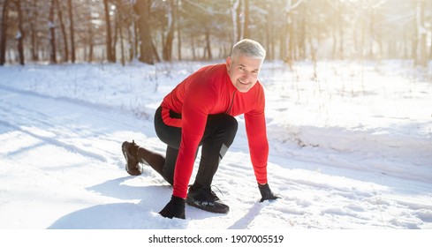 Outdoor Winter Activities. Mature Sportsman Getting Ready To Run Marathon On Snowy Road On Cold Sunny Day, Panorama. Athletic Senior Man Jogging Outside, Working Out In Frosty Weather