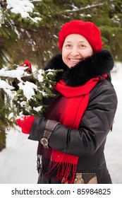 Outdoor Winter Portrait Of Mature Woman Near Fir-tree