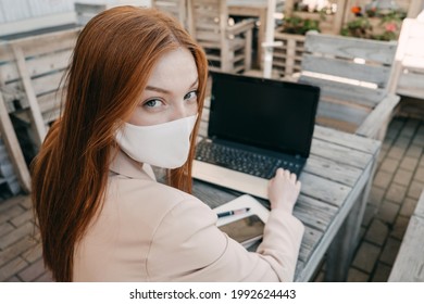 Outdoor Work Areas, Workplace. Take Office Outside, Work Moves Outdoors During Pandemic. Mobility, Autonomy, Work Remotely. Redhead Business Woman Working At Laptop Outdoors