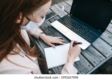 Outdoor Work Areas, Workplace. Take Office Outside, Work Moves Outdoors During Pandemic. Mobility, Autonomy, Work Remotely. Redhead Business Woman Working At Laptop Outdoors