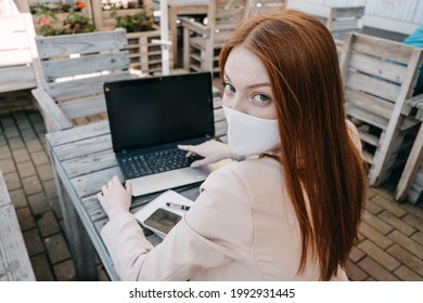 Outdoor Work Areas, Workplace. Take Office Outside, Work Moves Outdoors During Pandemic. Mobility, Autonomy, Work Remotely. Redhead Business Woman Working At Laptop Outdoors