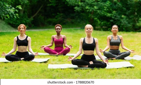 Outdoor Yoga Class. Group Of Diverse Girls Doing Breathing Exercises Or Meditation In Nature. Panorama