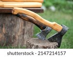 Outdoors displays handcrafted wood and metal crafts, natural wood cutting boards and axes 