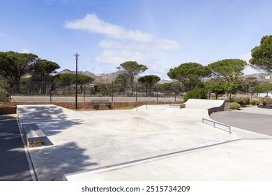 Outdoors, Empty skatepark with ramps and rails on sunny day, ready for skaters. Skateboarding, urban, sport, recreation, outdoor - Powered by Shutterstock