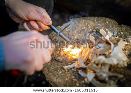 Outdoors makeing fire by flint