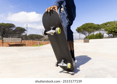 Outdoors, Performing trick on skateboard, african american teenage boy skateboarding in skate park. stunts, extreme, sports, urban, lifestyle, action - Powered by Shutterstock