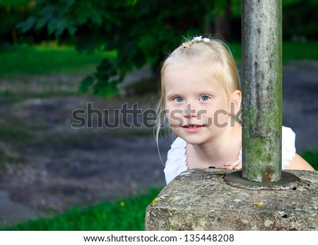 Outdoors portrait of beautiful  blonde little girl