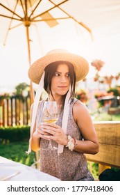 Outdoors Portrait Of A Beautiful Woman Drinking Wine In Winery