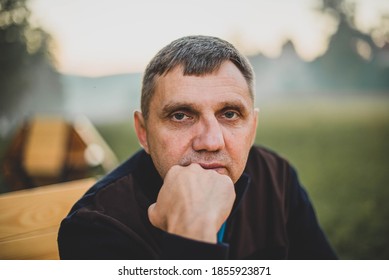 Outdoors Portrait Of A Man In A Street Cafe On A Background Of Fog. Senior Adult, Men. Real People Concept.