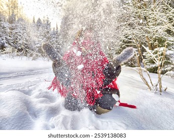 Outdoors portrait of young beautiful woman having fun with snow in winter forest. Girl in red shawl in cold day - Powered by Shutterstock