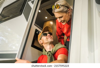 Outdoors And RVing Theme. Caucasian Couple In Their 40s Having Fun In Their Motorhome Camper Van. Vacation Time Camping.