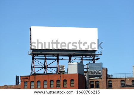 Outdor advertising in the city, mockup. Large billboard on roof top of brick building. 