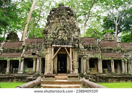 Outer gate of Ta Phrom - Iconic 12th century Angkor Khmer Temple with Tree roots intertwined with the temple structure, famous for Tomb Raider movie featuring Angeline Jolie at Siem Reap, Cambodia