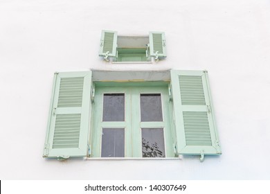 outer light green opened  and light green  inner closed window with white wall