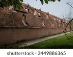 Outer wall of historic residences Begijnhoff in City Lier Belgium. Protected buildings are peaceful place to live and pretty landmark popular with tourists. Culture and history in Belgian life