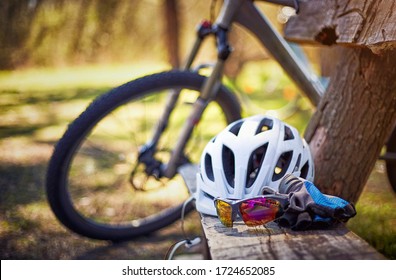 Outfit for bicycles, helmet, gloves on the bench on a sunny day.
 - Powered by Shutterstock