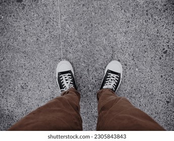 outfit jeans and shoes on the sidewalk - Powered by Shutterstock