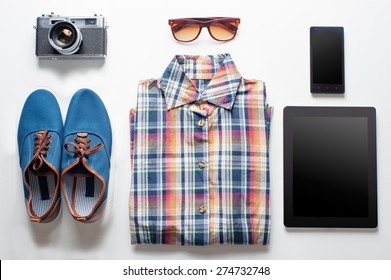 Outfit of traveler, student, teenager. Overhead of essentials for modern young person. Different objects on white wooden background. - Powered by Shutterstock