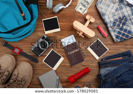 Outfit for travelling on wooden background