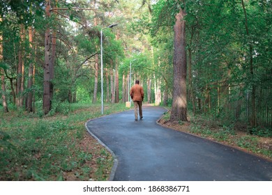 Outgoing Man On The Footpath In The Park On A Summer Day. Offended Man Leaves