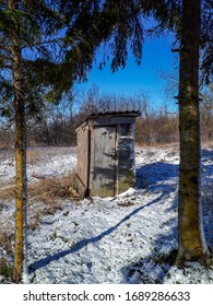 Outhouse Dry Toilet Cabin In Countryside In Winter. Old Toilet (wc) Made Of Wood In Latvia Countryside.