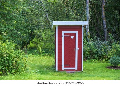 Outhouse With A Heart On The Door In A Garden