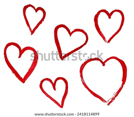outlines of hearts drawn with watercolor red paint on a white isolated background