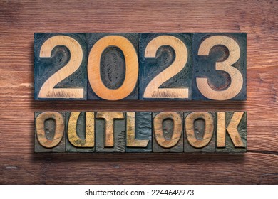 outlook 2023 phrase combined on vintage varnished wooden surface 

