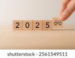 Outlook 2025. Economic, business outlook concept. Financial, business view or economic growth forecast for 2025. 2025 text, binoculars icon on wooden cube blocks, copy space and minimal background.