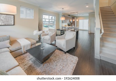 Outlook At The Luxury Modern Living Suite : Family Room  With Two Chairs  And The Kitchen At The Back. Interior Design Of A Brand New House.