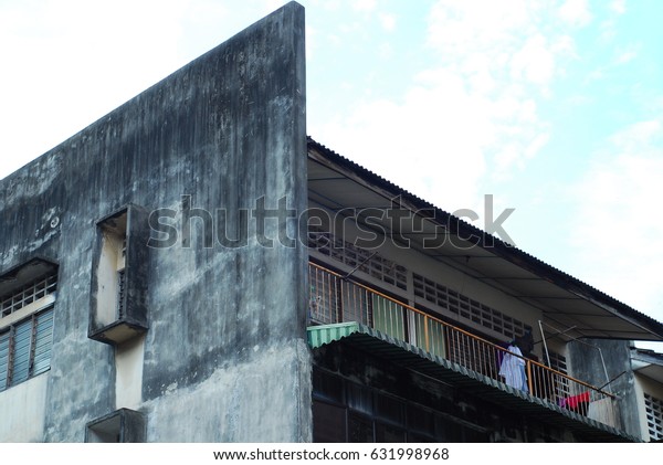 The outlook view of flat residence or low cost\
apartment in Kuala Lumpur with the hanging clothes visible at the\
balcony or windows.