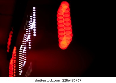 Out-of-focus effect, orange and red LED lights from the scoreboard. Suitable to be a background image. Electronic scoreboard for volleyball, basketball in the gym. - Powered by Shutterstock