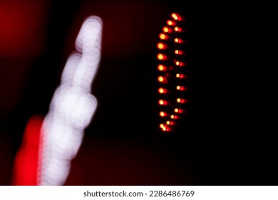 Out-of-focus effect, orange and red LED lights from the scoreboard. Suitable to be a background image. Electronic scoreboard for volleyball, basketball in the gym. - Powered by Shutterstock