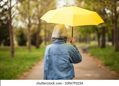 Outoor Picture Of A Young Woman With Yellow Umbrella