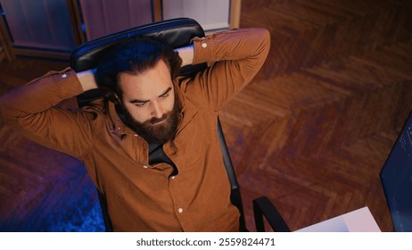 Outraged software engineer perplexed by impossible to remove bugs appearing while coding on computer desktop. Teleworking IT admin feeling baffled by script errors, putting hands on head, camera B