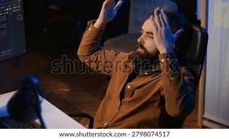 Outraged software engineer perplexed by impossible to remove bugs appearing while coding on computer desktop, teleworking IT admin feeling baffled by script errors, putting hands on head.