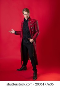 An Outrageous Young Man In A Daring Red Coat In A Vintage Noir Style, Photo On A Red Background