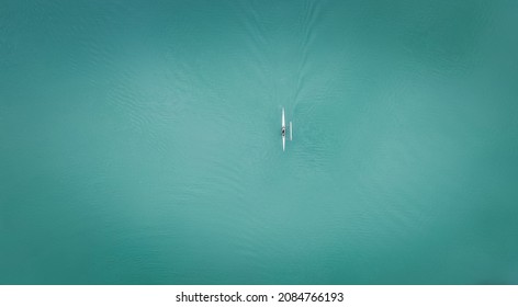 Outrigger Canoe Paddler On The Ocean Paddling Solo In Hawaii