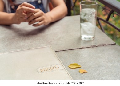 Outside Al Fresco dining experience with menu on table - Open air restaurant with romantic outdoor patio for dinner date - Mediterranean cafe lunch - Summer lifestyle, eating out and dating concept - Powered by Shutterstock