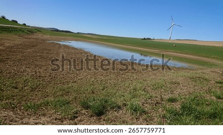outside between lakes and green fields and blue sky 