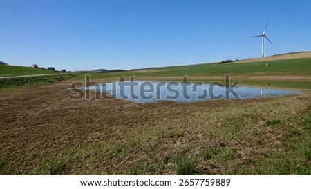 outside between lakes and green fields and blue sky 