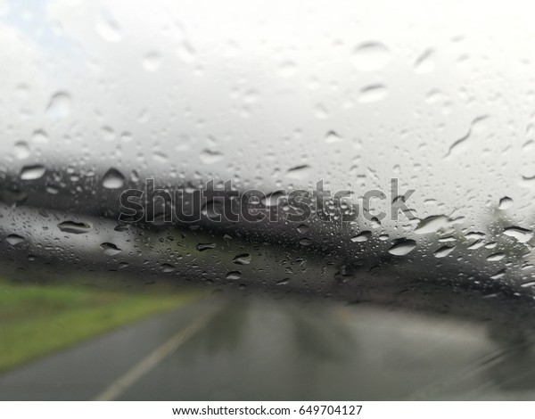 Outside the car in the raining day, View from car
seat. focus rain