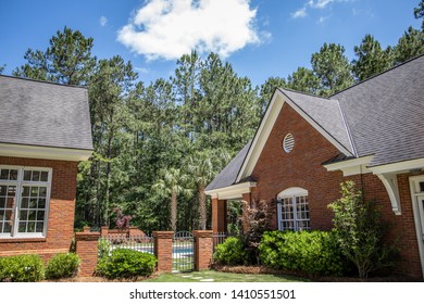 Outside Of Large Brick Home Pool House From The Side